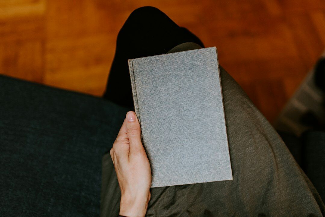 person reading book at home
