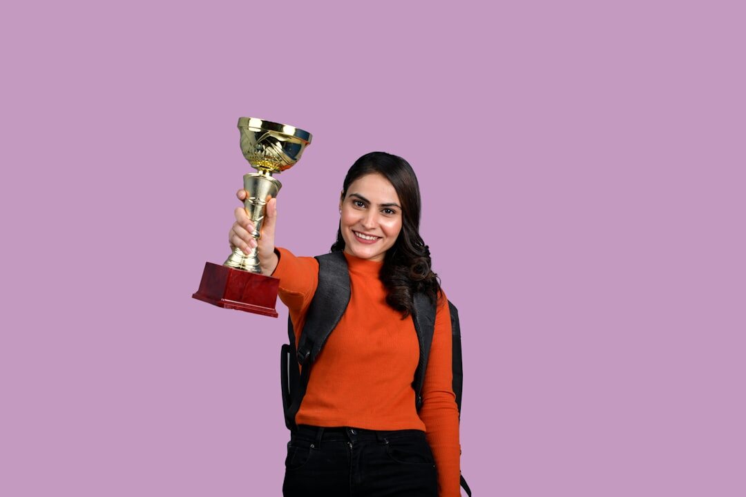 Celebrity holding an award trophy on stage